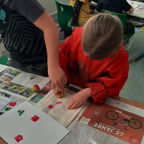 zwei Kinder bedrucken eine Tasche